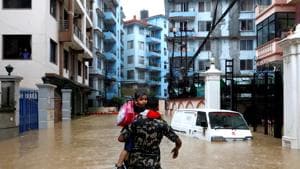 A member of Nepalese army carrying a child walks along the flooded colony in Kathmandu, Nepal .(REUTERS File Photo)