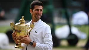 Novak Djokovic holds the winner's trophy during the presentation.(AFP)
