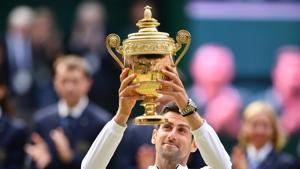 Serbia's Novak Djokovic raises the winner's trophy after beating Switzerland's Roger Federer(AFP) Serbia's Novak Djokovic raises the winner's trophy after beating Switzerland's Roger Federer(AFP)