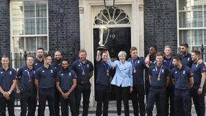 Britain's Prime Minister Theresa May smiles as she stands with England cricket captain Eoin Morgan.(AP) Britain's Prime Minister Theresa May smiles as she stands with England cricket captain Eoin Morgan.(AP)