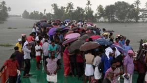 IMD has predicted that Kerala will face heavy to extremely heavy rainfall in the next 24 hours. IMD has also issued red alert in 6 districts of Kerala. In this picture, volunteers are seen crossing the Pampa river to reach to flood-affected areas during the devastating floods of 2018.(REUTERS) IMD has predicted that Kerala will face heavy to extremely heavy rainfall in the next 24 hours. IMD has also issued red alert in 6 districts of Kerala. In this picture, volunteers are seen crossing the Pampa river to reach to flood-affected areas during the devastating floods of 2018.(REUTERS)
