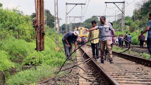 CR staff worked to fix the broken cable.(HT Photo) CR staff worked to fix the broken cable.(HT Photo)