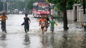 Children play on a water-logged road following heavy monsoon rain in Varanasi, Thursday, July 11, 2019. A flood alert has been sounded for 15 districts of east UP following heavy rain in the region.(PTI) Children play on a water-logged road following heavy monsoon rain in Varanasi, Thursday, July 11, 2019. A flood alert has been sounded for 15 districts of east UP following heavy rain in the region.(PTI)