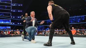 Shane McMahon pleads with Kevin Owens as Roman Reigns watches on.(WWE)