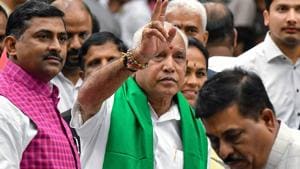 Senior leader of Bharatiya Janata Party (BJP), B.S. Yediyurappa (C), flashes the victory sign to his supporters and party workers prior to his swearing for the fourth time as the Karnataka Chief Minister on July 26, 2019.(AFP photo)