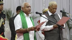 Karnataka state Governor Vajubhai Vala, right, administers the oath of office to Bharatiya Janata Party (BJP) leader B.S. Yeddyurappa as Chief Minister of the southern state in Bangalore, India, Friday, July 26, 2019.(AP photo)
