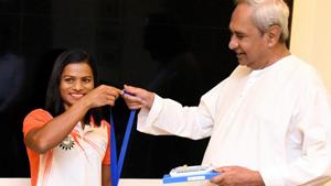Sprinter Dutee Chand shows Odisha Chief Minister Naveen Pattnaik the gold medal she won at World University Games.(PTI) Sprinter Dutee Chand shows Odisha Chief Minister Naveen Pattnaik the gold medal she won at World University Games.(PTI)
