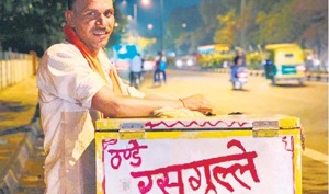 Jagram sells the unusal combo of white rasgulla and white bread on his cycle cart —from Ashram to ITO.(HT Photo) Jagram sells the unusal combo of white rasgulla and white bread on his cycle cart —from Ashram to ITO.(HT Photo)