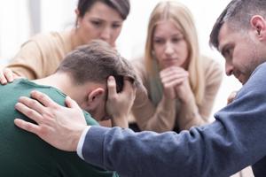 Close-up of a devastated young man holding his head in his hands and a group of friends in a supportive pose around him(Getty Images/iStockphoto) Close-up of a devastated young man holding his head in his hands and a group of friends in a supportive pose around him(Getty Images/iStockphoto)