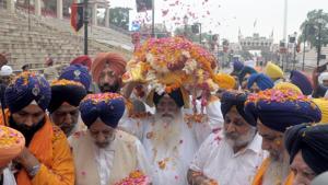 Head priest of Golden Temple, Giani Jagtar Singh (C) carries the Guru Granth Sahib during the 'Nagar Kirtan' procession to mark the 550th birth anniversary of Guru Nanak Dev, at the Wagah Border Post, on Thursday, August 1, 2019.(Sameer Sehgal / HT Photo) Head priest of Golden Temple, Giani Jagtar Singh (C) carries the Guru Granth Sahib during the 'Nagar Kirtan' procession to mark the 550th birth anniversary of Guru Nanak Dev, at the Wagah Border Post, on Thursday, August 1, 2019.(Sameer Sehgal / HT Photo)