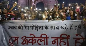 New Delhi, India - July 29, 2019: People use their mobile phones as torches while gathered for a silent protest in solidarity with the Unnao rape case victim, at India Gate in New Delhi, India, on Monday, July 29, 2019. (Photo by Burhaan Kinu/ Hindustan Times)(Burhaan Kinu/HT PHOTO) New Delhi, India - July 29, 2019: People use their mobile phones as torches while gathered for a silent protest in solidarity with the Unnao rape case victim, at India Gate in New Delhi, India, on Monday, July 29, 2019. (Photo by Burhaan Kinu/ Hindustan Times)(Burhaan Kinu/HT PHOTO)