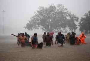 Kerala rain: Members of a rescue team wade through a water-logged area during heavy rains on the outskirts of Kochi(REUTERS) Kerala rain: Members of a rescue team wade through a water-logged area during heavy rains on the outskirts of Kochi(REUTERS)