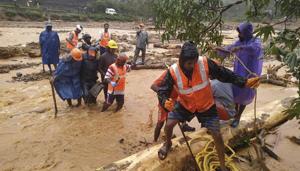 NDRF personnel help move flood victims to safer areas in Wayanad district in Kerala.(AP) NDRF personnel help move flood victims to safer areas in Wayanad district in Kerala.(AP)