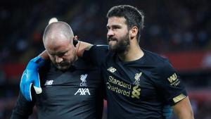 Liverpool's Alisson is helped off the pitch as he is substituted after sustaining an injury.(REUTERS) Liverpool's Alisson is helped off the pitch as he is substituted after sustaining an injury.(REUTERS)