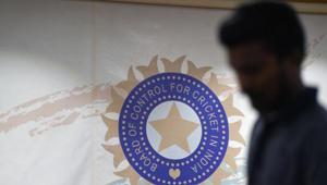 A man walks in front of the logo for the Board of Control for Cricket in India (BCCI).(AFP) A man walks in front of the logo for the Board of Control for Cricket in India (BCCI).(AFP)