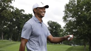 Tiger Woods smiles as he leaves the 14th green during the pro-am round of the BMW Championship golf tournament at Medinah Country Club.(AP) Tiger Woods smiles as he leaves the 14th green during the pro-am round of the BMW Championship golf tournament at Medinah Country Club.(AP)
