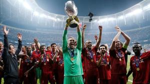 Liverpool's Adrian lifts the trophy as he celebrates winning the UEFA Super Cup with team mates.(Action Images via Reuters) Liverpool's Adrian lifts the trophy as he celebrates winning the UEFA Super Cup with team mates.(Action Images via Reuters)