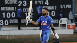 Virat Kohli raises his bats to celebrate reaching his century.(AP) Virat Kohli raises his bats to celebrate reaching his century.(AP)