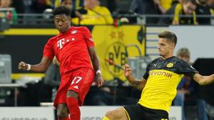 Bayern Munich's David Alaba in action with Borussia Dortmund's Julian Weigl.(REUTERS) Bayern Munich's David Alaba in action with Borussia Dortmund's Julian Weigl.(REUTERS)