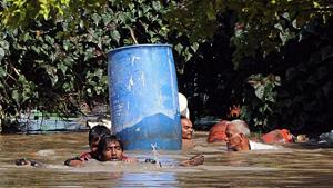 Villagers wade through the flooded street after heavy rainfall at Krishna Lanka in Vijayawada, Andhra Pradesh(ANI Photo) Villagers wade through the flooded street after heavy rainfall at Krishna Lanka in Vijayawada, Andhra Pradesh(ANI Photo)