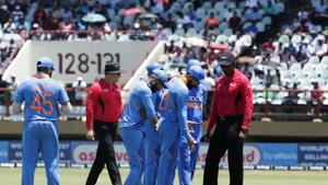 India's cricket players and umpires inspect the pitch.(AP) India's cricket players and umpires inspect the pitch.(AP)