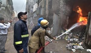 Fire fighters trying to douse the flames after fire broke out at Ahuja Enterprises at Central Market on Gill Road, Ludhiana, on Friday.(Gurpreet Singh/HT) Fire fighters trying to douse the flames after fire broke out at Ahuja Enterprises at Central Market on Gill Road, Ludhiana, on Friday.(Gurpreet Singh/HT)