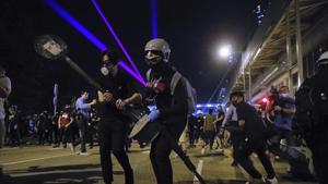 Demonstrators stand outside the Yuen Long MTR station during a protest in Hong Kong.(AP) Demonstrators stand outside the Yuen Long MTR station during a protest in Hong Kong.(AP)