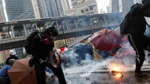 Demonstrators protect themselves from tear gas canisters during a protest in Tsuen Wan, Hong Kong .(Reuters Photo) Demonstrators protect themselves from tear gas canisters during a protest in Tsuen Wan, Hong Kong .(Reuters Photo)