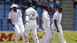 West Indies' captain Jason Holder, left, celebrates the dismissal of India's Cheteshwar Pujara, bowled by Kemar Roach.(AP) West Indies' captain Jason Holder, left, celebrates the dismissal of India's Cheteshwar Pujara, bowled by Kemar Roach.(AP)