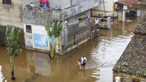 Kolhapur: A man walks through a flooded area following incessant rainfall in Kolhapur district in Maharashtra on August 12, 2019.(PTI File Photo) Kolhapur: A man walks through a flooded area following incessant rainfall in Kolhapur district in Maharashtra on August 12, 2019.(PTI File Photo)