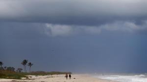 People walk on a largely deserted beach of the Atlantic Ocean on the barrier island in Vero Beach, Fla., on Sunday before Hurricane Dorian made landfall.(AP File Photo) People walk on a largely deserted beach of the Atlantic Ocean on the barrier island in Vero Beach, Fla., on Sunday before Hurricane Dorian made landfall.(AP File Photo)
