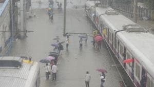 People walk on the railway track as trains stop working due to water logging on the railway track at Matunga (West) railway station in Mumbai.(Vijayanand Gupta/HT Photo) People walk on the railway track as trains stop working due to water logging on the railway track at Matunga (West) railway station in Mumbai.(Vijayanand Gupta/HT Photo)