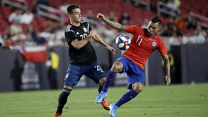 Chile's Eduardo Vargas, right, is defended by Argentina's Giovani Lo Celso in an international friendly in Los Angeles.(AP) Chile's Eduardo Vargas, right, is defended by Argentina's Giovani Lo Celso in an international friendly in Los Angeles.(AP)