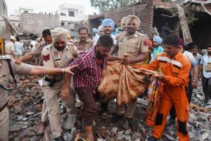 Police and NNDRF team resuce dead bodies after collapsed cracker factory building after blast at Batala.(HT Photo) Police and NNDRF team resuce dead bodies after collapsed cracker factory building after blast at Batala.(HT Photo)