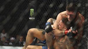 Khabib Nurmagomedov locks in a rear naker choke on Dustin Poirier at UFC 242, in Yas Mall in Abu Dhabi.(AP) Khabib Nurmagomedov locks in a rear naker choke on Dustin Poirier at UFC 242, in Yas Mall in Abu Dhabi.(AP)