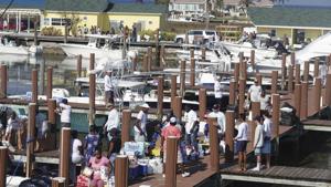 People carry food and supplies after several boats arrived with supples from the Florida Coast on Saturday at Old Bahama Bay Marina, West End, Bahamas. The hurricane death toll is rising in the Bahamas, in what its leader calls "this hour of darkness."(AP Photo) People carry food and supplies after several boats arrived with supples from the Florida Coast on Saturday at Old Bahama Bay Marina, West End, Bahamas. The hurricane death toll is rising in the Bahamas, in what its leader calls "this hour of darkness."(AP Photo)