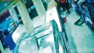 The helmet-clad man (left) pointed the pistol at the staff (right) behind the delivery counter and shot four rounds.(cctv camera grab) The helmet-clad man (left) pointed the pistol at the staff (right) behind the delivery counter and shot four rounds.(cctv camera grab)