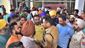 A cop trying to pacify protesters in Ludhiana on Tuesday.(HT Photo) A cop trying to pacify protesters in Ludhiana on Tuesday.(HT Photo)