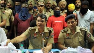 Police officials with arrested drugs peddlars in Jalandhar, last month.(Pardeep Pandit / HT Photo) Police officials with arrested drugs peddlars in Jalandhar, last month.(Pardeep Pandit / HT Photo)