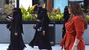 Saudi human resources professional Mashael al-Jaloud, 33, walks in western clothes past women wearing niqab, an Islamic dress-code for women, at a commercial area in the Saudi capital Riyadh on September 3, 2019. (Photo by FAYEZ NURELDINE / AFP)(AFP) Saudi human resources professional Mashael al-Jaloud, 33, walks in western clothes past women wearing niqab, an Islamic dress-code for women, at a commercial area in the Saudi capital Riyadh on September 3, 2019. (Photo by FAYEZ NURELDINE / AFP)(AFP)