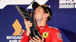 Ferrari's Sebastian Vettel kisses the trophy as he celebrates after winning the race.(REUTERS) Ferrari's Sebastian Vettel kisses the trophy as he celebrates after winning the race.(REUTERS)