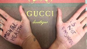 Model Ayesha Tan Jones held up “Mental Health Is Not Fashion” on her hands on her way down the runway.(Ayesha Tan Jones/Instagram)