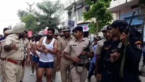 A video of the parading incident that went viral on Sunday, showed that the 13 gangsters taken out in their undergarments were hand-cuffed and made to walk for a kilometre in the crowded marketplace.(PTI image) A video of the parading incident that went viral on Sunday, showed that the 13 gangsters taken out in their undergarments were hand-cuffed and made to walk for a kilometre in the crowded marketplace.(PTI image)