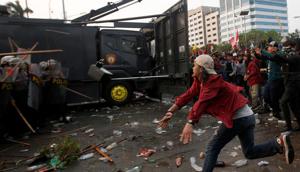 The protest outside Parliament in Indonesia saw police fire tear gas and water cannons to disperse thousands of rock-throwing students.(REUTERS Photot)