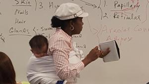 Twitter user @AnnaKhadejah, who is the professor’s daughter, tweeted a picture of her mother, Dr. Ramata Sissoko Cisse in class with the baby on her back. Twitter user @AnnaKhadejah, who is the professor’s daughter, tweeted a picture of her mother, Dr. Ramata Sissoko Cisse in class with the baby on her back.