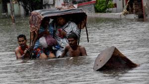 A rickshaw puller wades through a flooded street after heavy rainfall, in Patna.(ANI Photo) A rickshaw puller wades through a flooded street after heavy rainfall, in Patna.(ANI Photo)