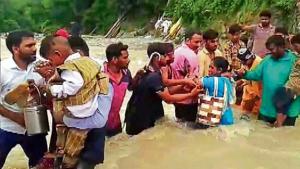 Pilgrims cross a flooded street after the flash flood at Shakumbhari Devi temple in Saharanpur on Sunday, (R) a view of a waterlogged street outside Adampur police station following heavy rains, in Varanasi on Sunday.(ANI Photo) Pilgrims cross a flooded street after the flash flood at Shakumbhari Devi temple in Saharanpur on Sunday, (R) a view of a waterlogged street outside Adampur police station following heavy rains, in Varanasi on Sunday.(ANI Photo)