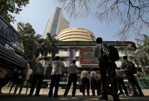 People look at a screen displaying the Sensex results on the facade of the Bombay Stock Exchange (BSE) building in Mumbai.(Photo: Reuters) People look at a screen displaying the Sensex results on the facade of the Bombay Stock Exchange (BSE) building in Mumbai.(Photo: Reuters)