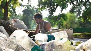 A scrap vendor sorting disposable plastic bottles. Uncollected plastic waste is a massive problem. A scrap vendor sorting disposable plastic bottles. Uncollected plastic waste is a massive problem.