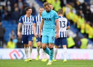 Tottenham Hotspur's Harry Kane looks dejected as Brighton and Hove Albion players celebrate at the end of the match.(REUTERS) Tottenham Hotspur's Harry Kane looks dejected as Brighton and Hove Albion players celebrate at the end of the match.(REUTERS)